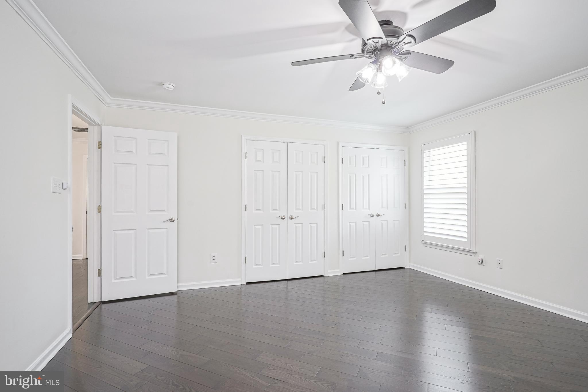 6101 Church Road Mount Laurel, NJ 08054 - Photo 35 of 64 an empty room with wooden floor ceiling fan and windows