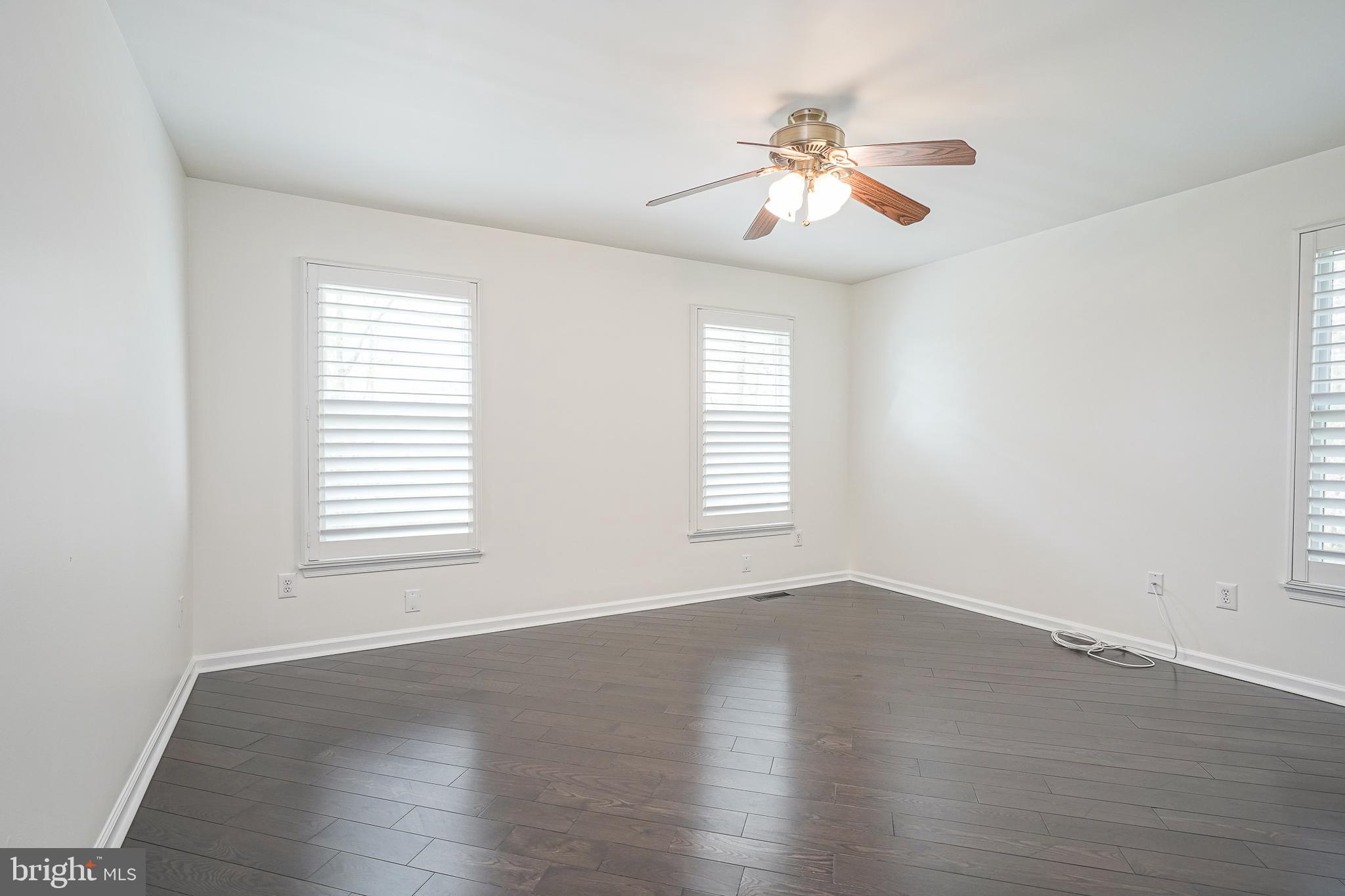 6101 Church Road Mount Laurel, NJ 08054 - Photo 40 of 64 an empty room with wooden floor chandelier fan and windows