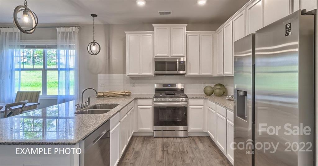 7200 Indigo Way Denver, NC 28037 - Photo 2 of 11 a kitchen with a sink stove and refrigerator