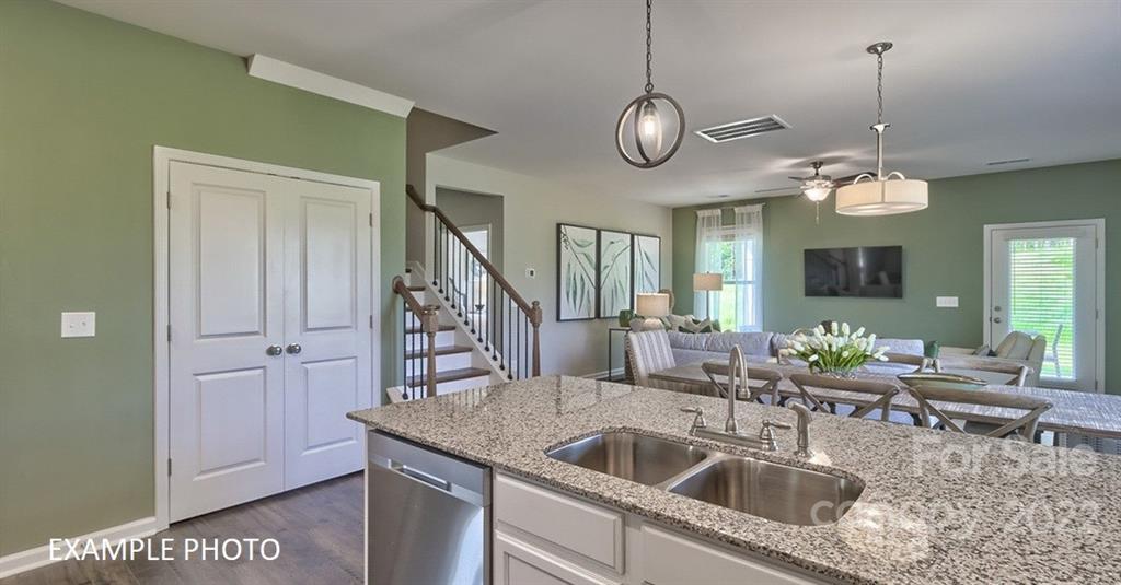 7200 Indigo Way Denver, NC 28037 - Photo 5 of 11 a view of a kitchen island a chandelier and wooden floor