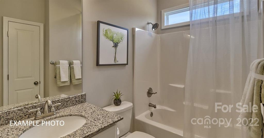 7200 Indigo Way Denver, NC 28037 - Photo 8 of 11 a bathroom with a granite countertop tub sink and mirror
