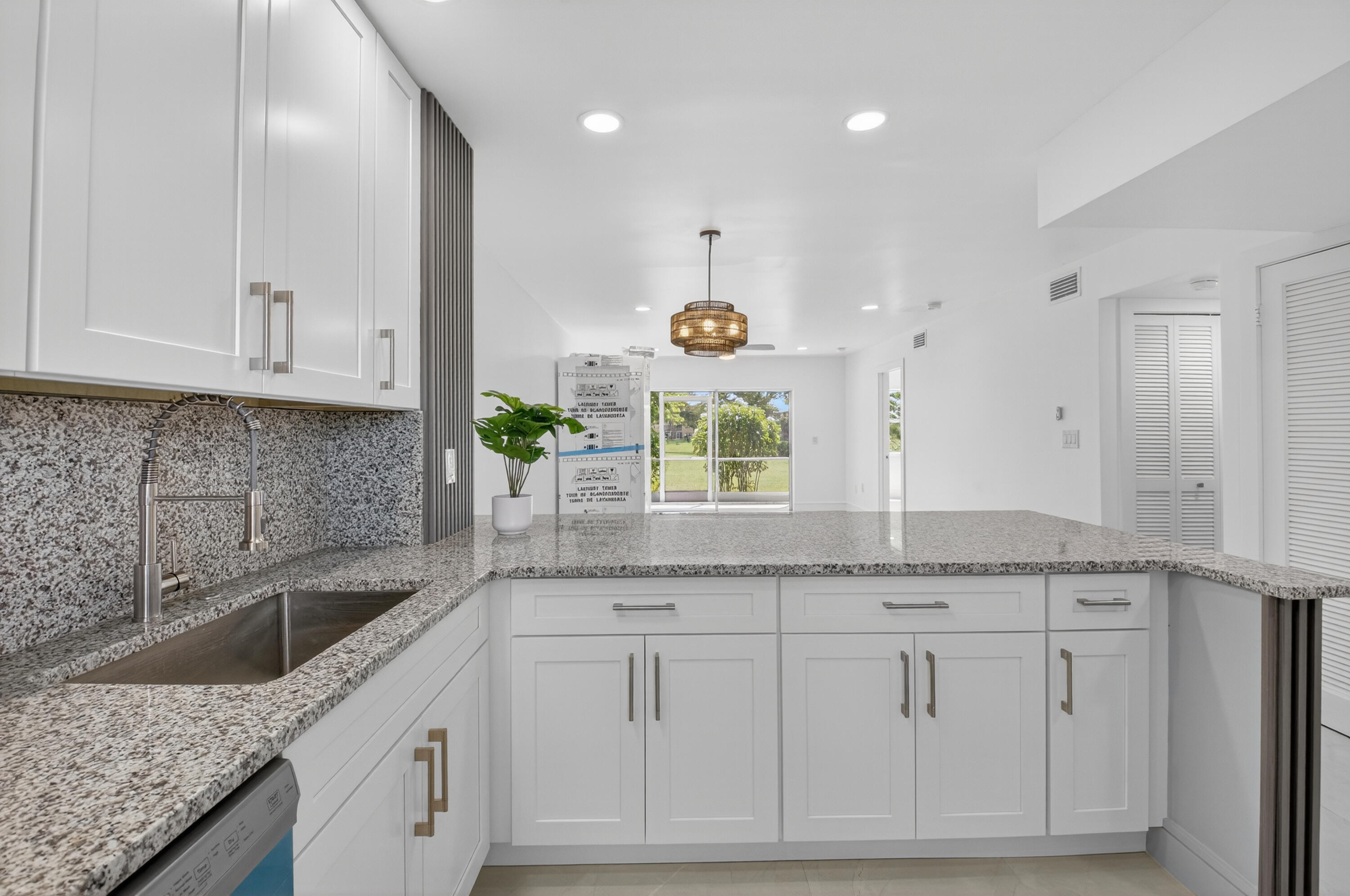 9880 Marina Boulevard, Unit 1509 Boca Raton, FL 33428 - Photo 1 of 43 a kitchen with granite countertop a sink and white cabinets