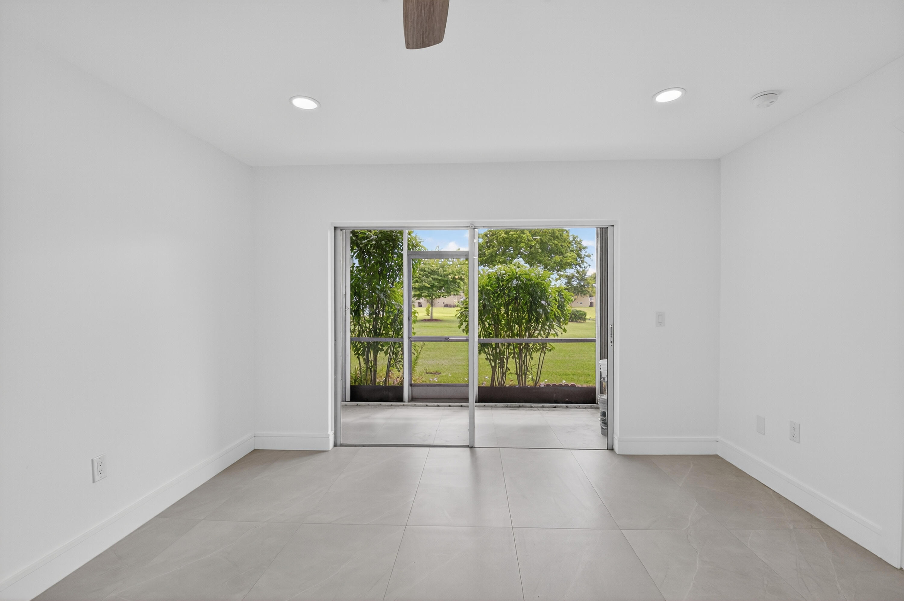 9880 Marina Boulevard, Unit 1509 Boca Raton, FL 33428 - Photo 14 of 43 a view of an empty room with a sliding door