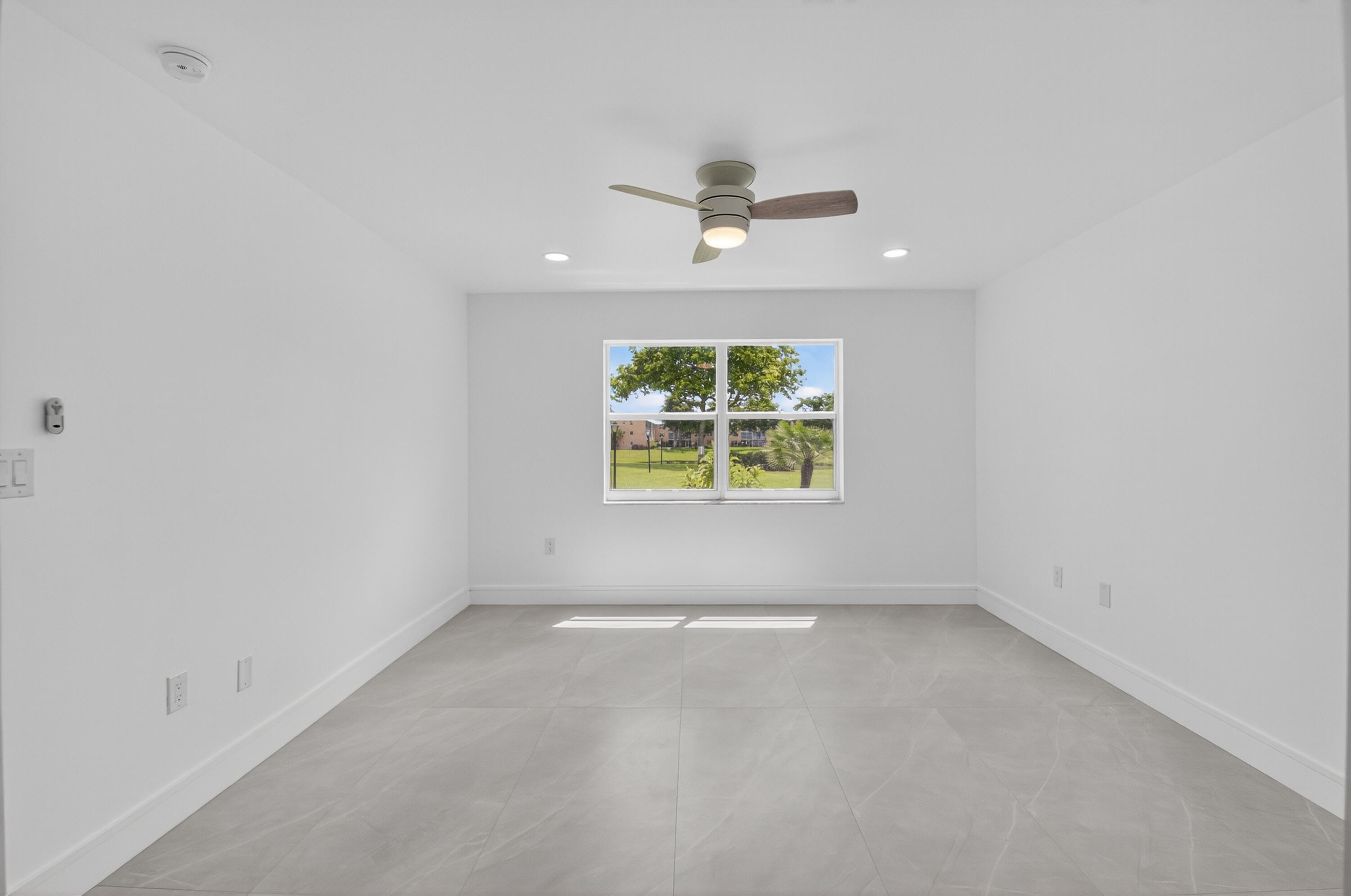 9880 Marina Boulevard, Unit 1509 Boca Raton, FL 33428 - Photo 16 of 43 an empty room with windows and chandelier fan