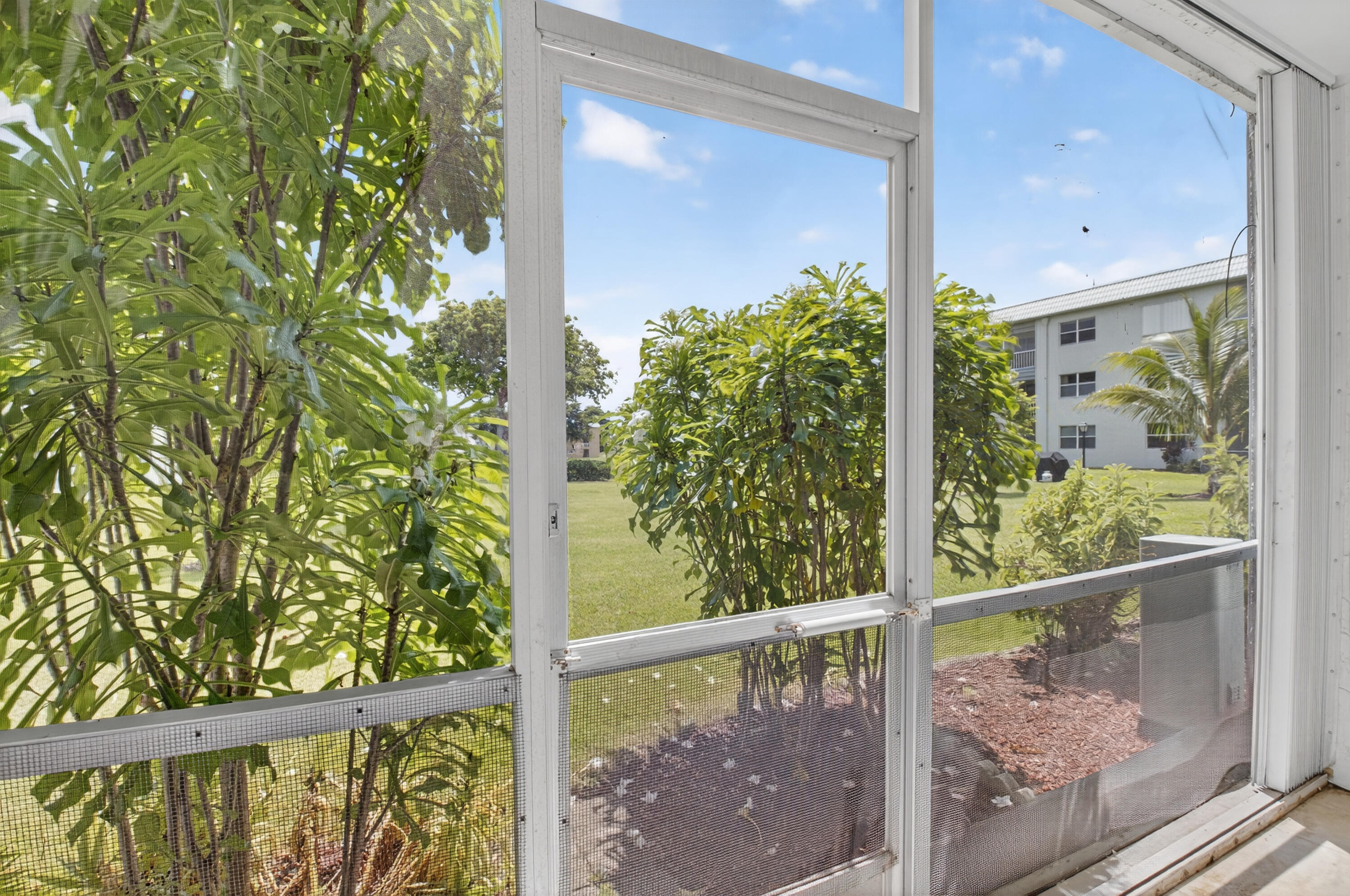 9880 Marina Boulevard, Unit 1509 Boca Raton, FL 33428 - Photo 23 of 43 a view of a balcony with a tree
