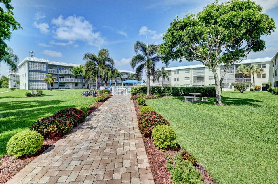 9880 Marina Boulevard, Unit 1509 Boca Raton, FL 33428 - Photo 26 of 43 a view of a street with a building and a garden