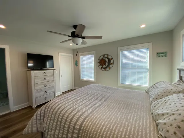 a bedroom with a bed and a tv