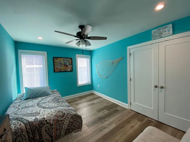 a bedroom with a large bed and a window
