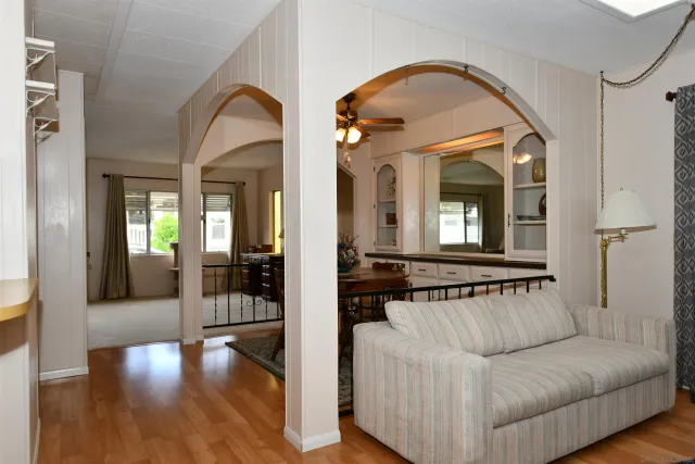 a living room with furniture and a mirror