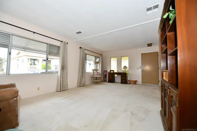 a view of a livingroom with furniture and a window