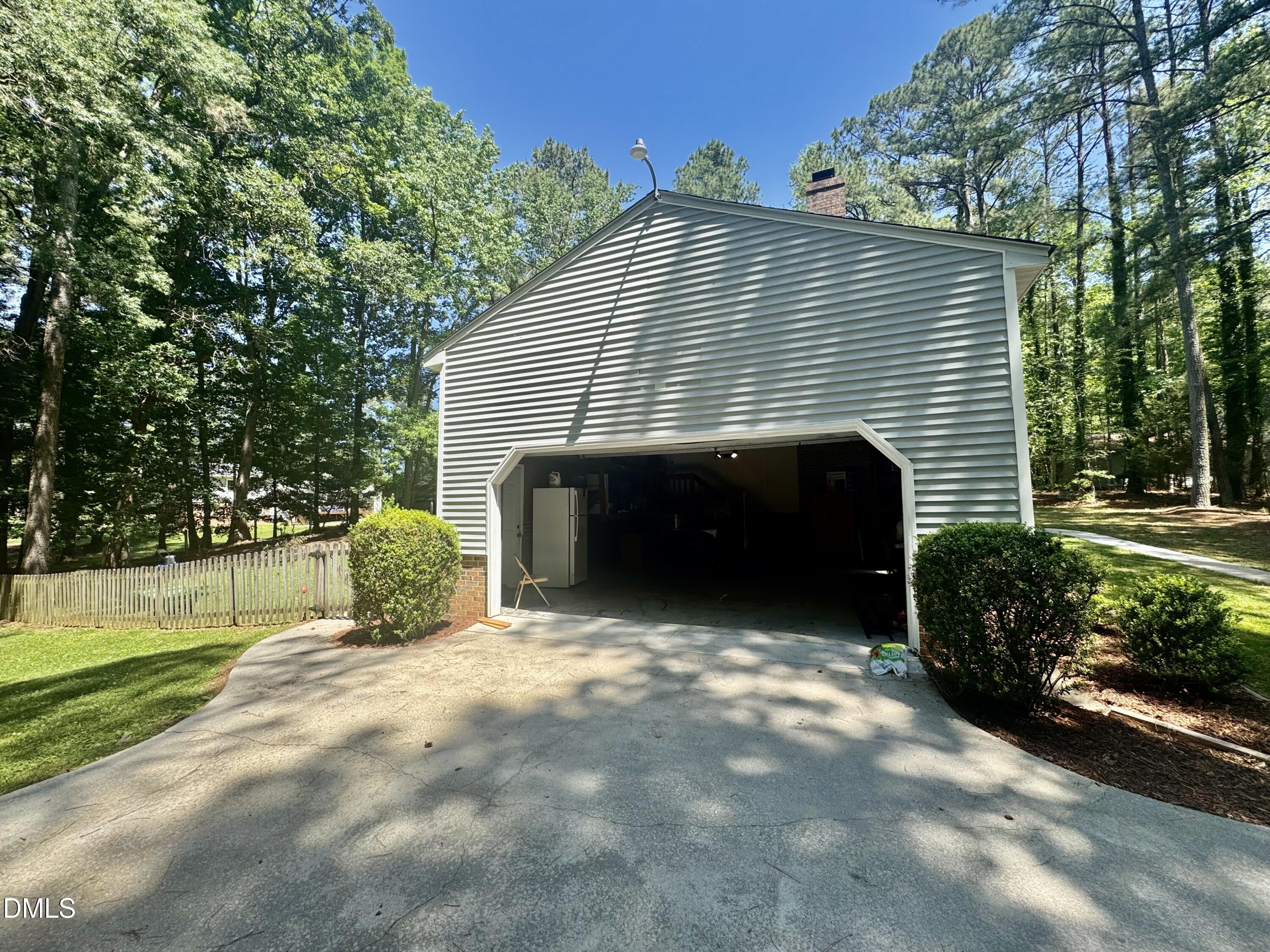 84 Wintergreen Road Henderson, NC 27537 - Photo 5 of 49 a front view of a house with a yard and garage