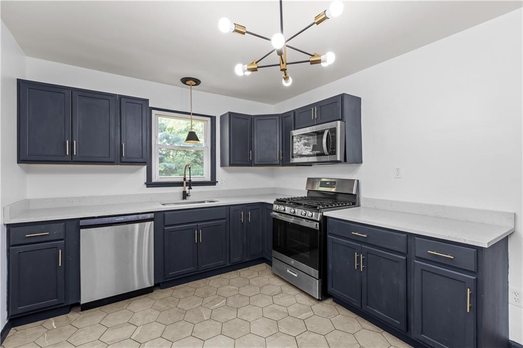 146 Ridgewood Road Coraopolis, PA 15108 - Photo 11 of 31 a kitchen with stainless steel appliances granite countertop stove top oven a sink dishwasher and cabinets