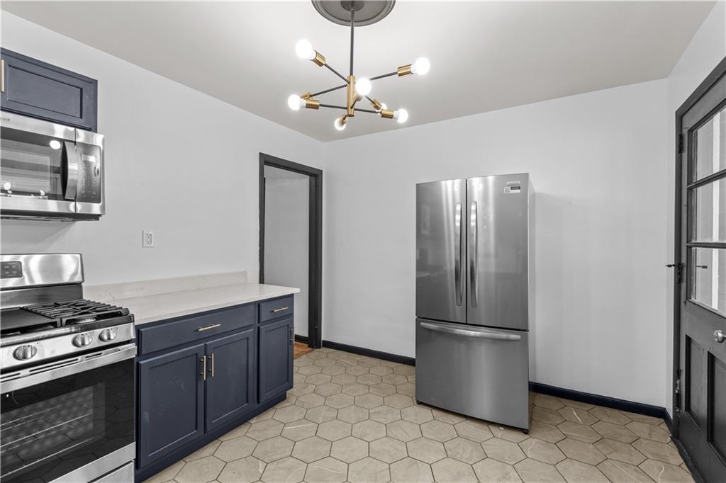 146 Ridgewood Road Coraopolis, PA 15108 - Photo 12 of 31 a kitchen with stainless steel appliances granite countertop a refrigerator a stove and a sink