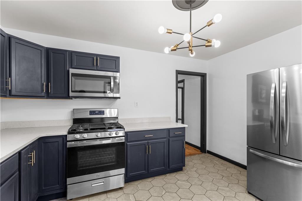 146 Ridgewood Road Coraopolis, PA 15108 - Photo 15 of 31 a kitchen with stainless steel appliances a stove a refrigerator and a microwave