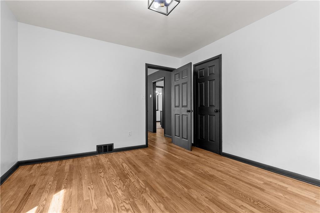 146 Ridgewood Road Coraopolis, PA 15108 - Photo 18 of 31 a view of an empty room with wooden floor and a window