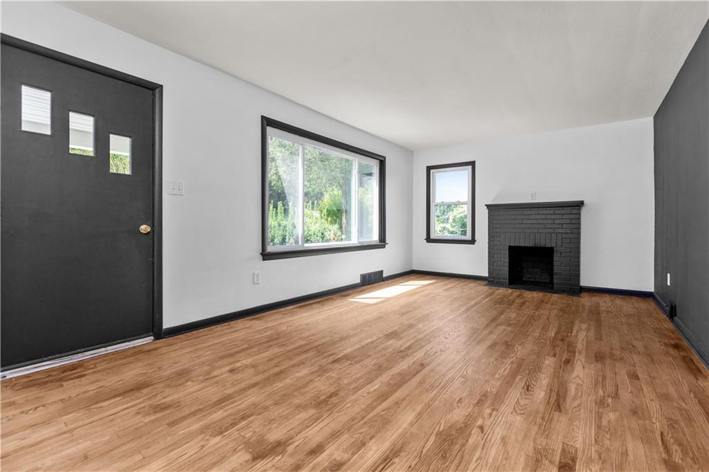 146 Ridgewood Road Coraopolis, PA 15108 - Photo 4 of 31 a view of an empty room with wooden floor and a window