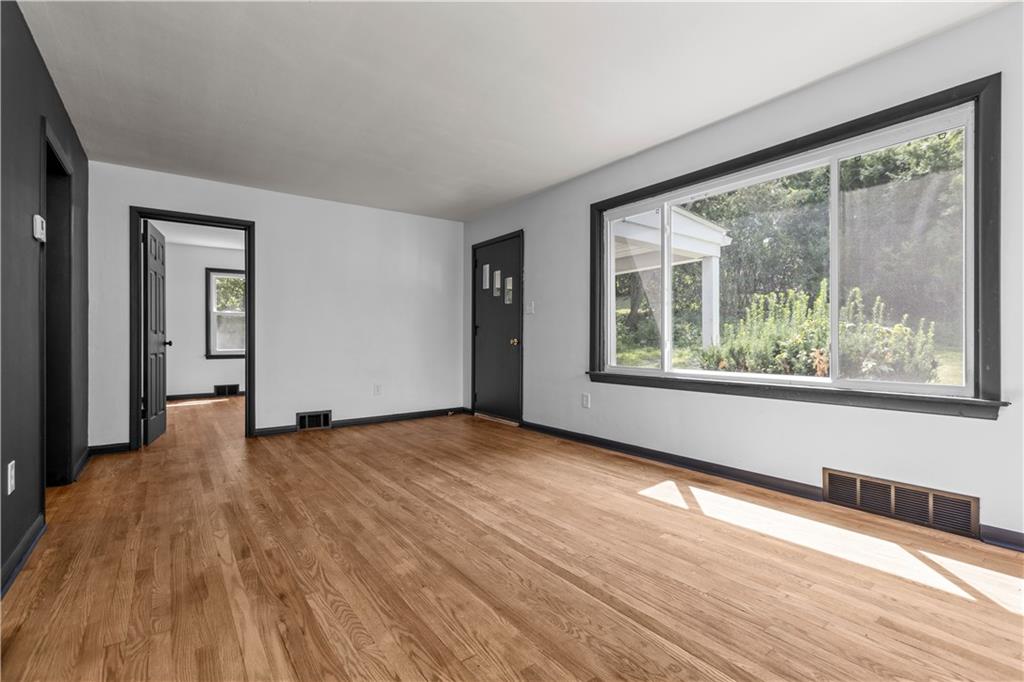 146 Ridgewood Road Coraopolis, PA 15108 - Photo 5 of 31 a view of an empty room with wooden floor and a window
