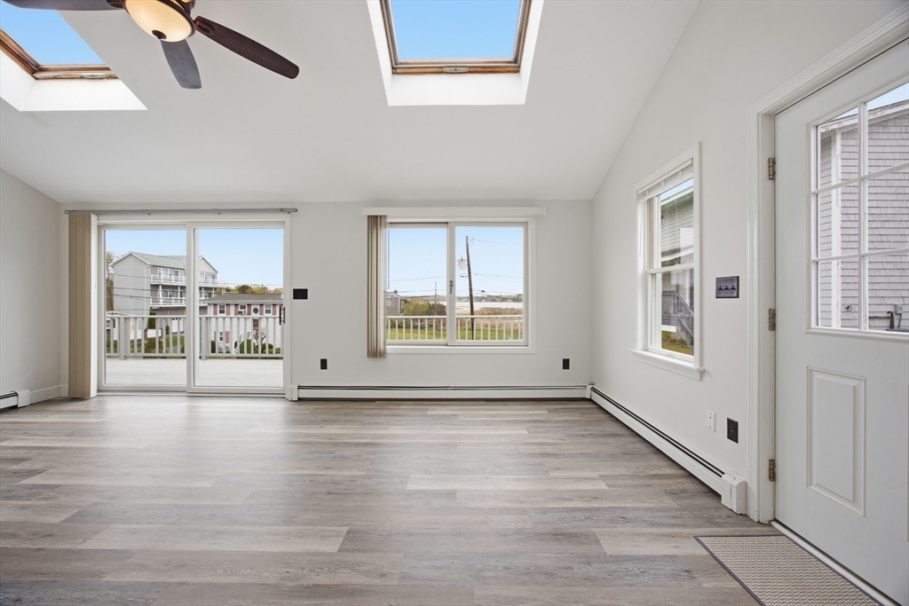 192 Swifts Beach Road Wareham, MA 02571 - Photo 21 of 38 a view of an empty room with a window and wooden floor