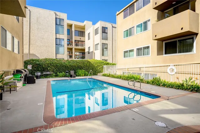 a view of a swimming pool with outdoor seating