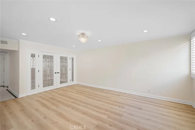 a view of an empty room with wooden floor