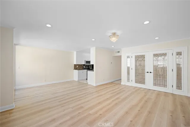 a view of empty room with wooden floor