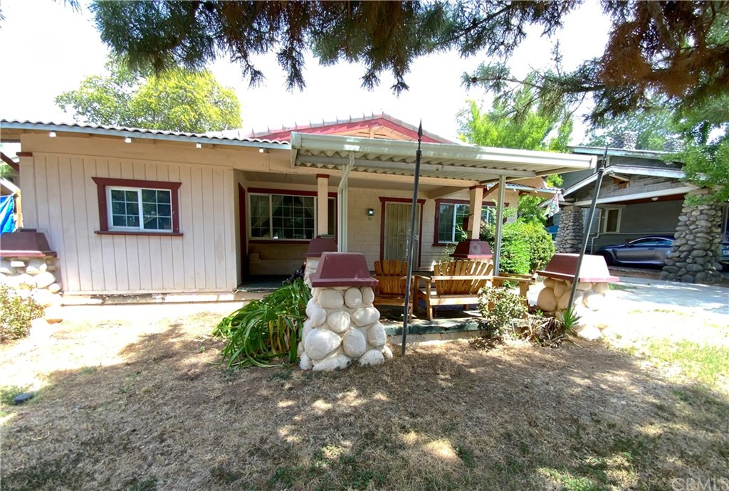 a view of a patio with a table and chairs under an umbrella