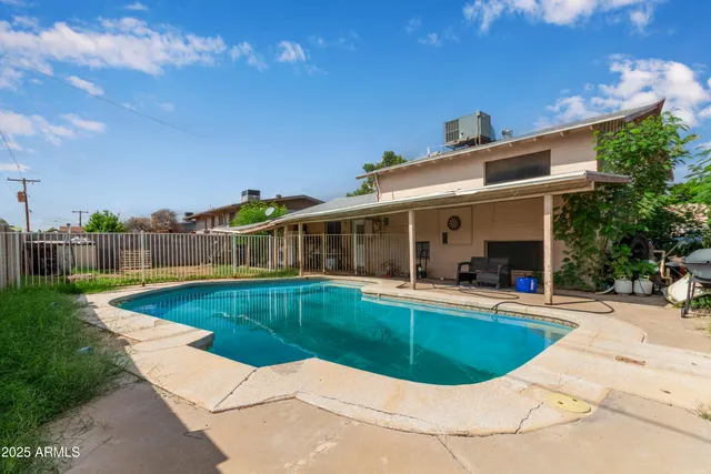 a view of a house with swimming pool and sitting area