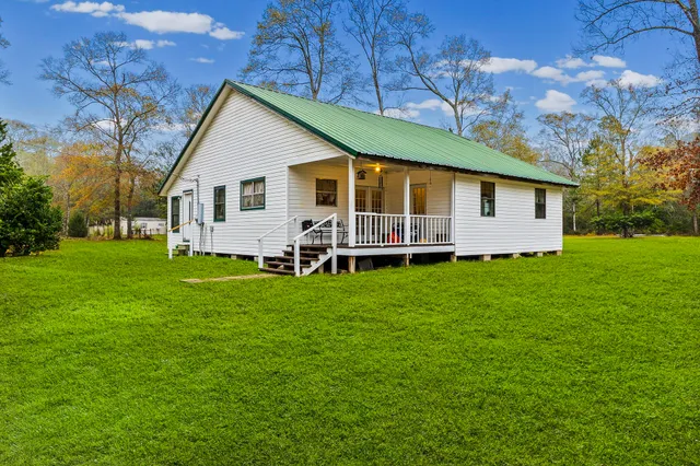a front view of house with yard and green space