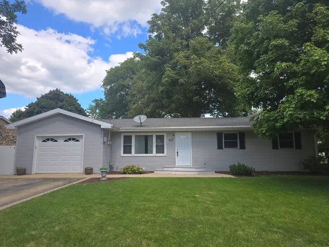 a front view of house with yard and green space