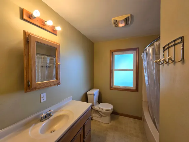 a bathroom with a sink toilet and mirror