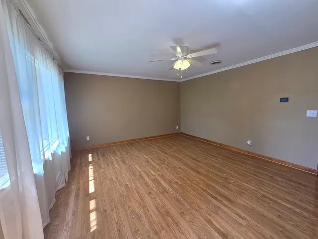 wooden floor in an empty room with a window