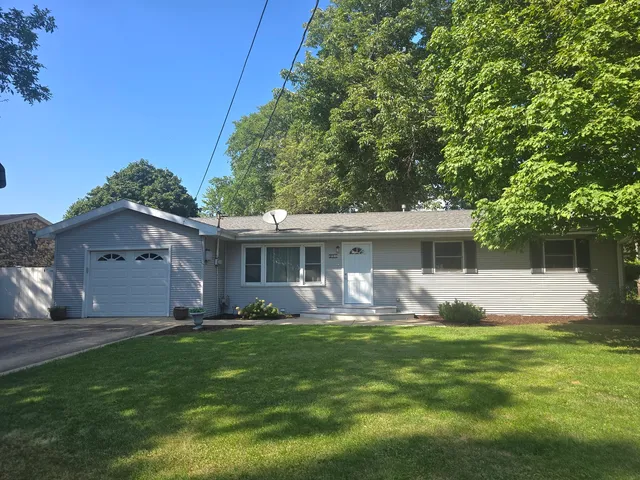 a front view of house with a garden and patio