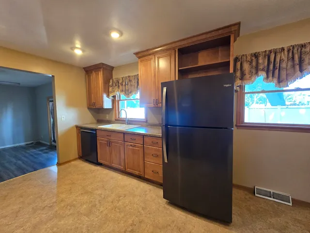 a kitchen with a refrigerator and a sink