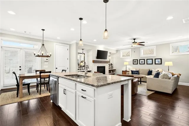 a open kitchen with stainless steel appliances granite countertop a stove and kitchen island with wooden floor