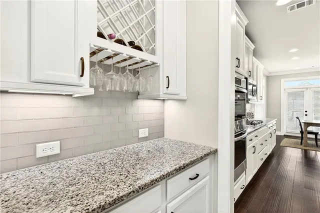 a kitchen with granite countertop a sink and a stove