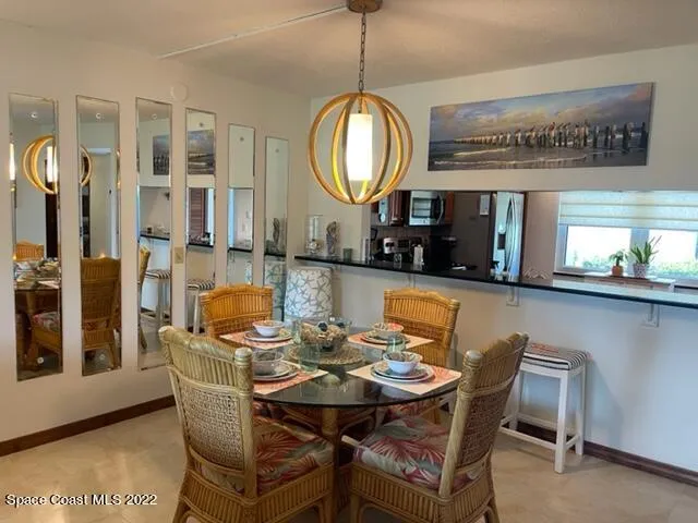 a view of a dining room with furniture and a chandelier