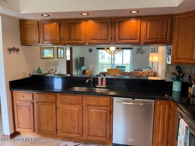 a kitchen with granite countertop a sink cabinets and window