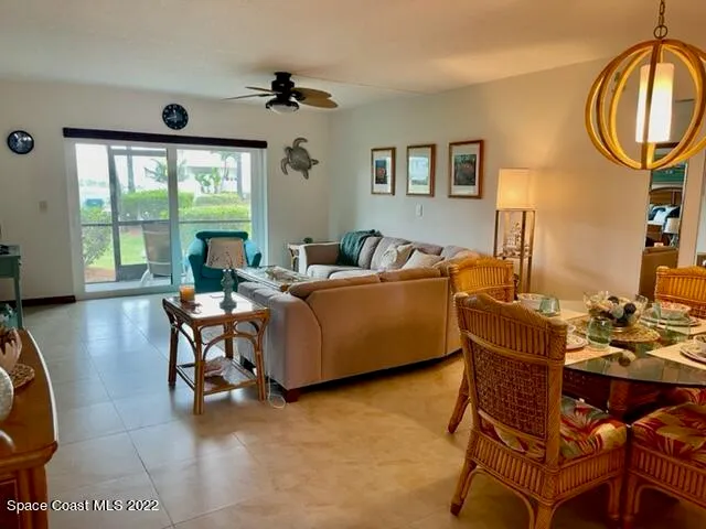 a living room with furniture a window and a flat screen tv