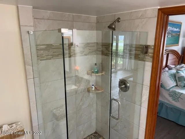 a bathroom with a glass shower door