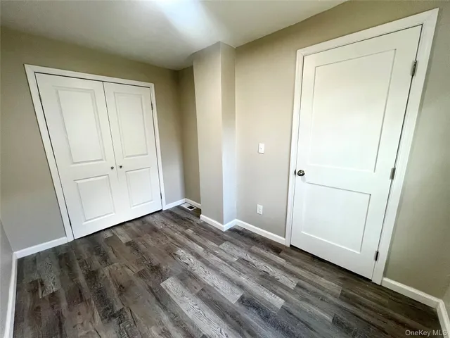 a view of an empty room and wooden floor