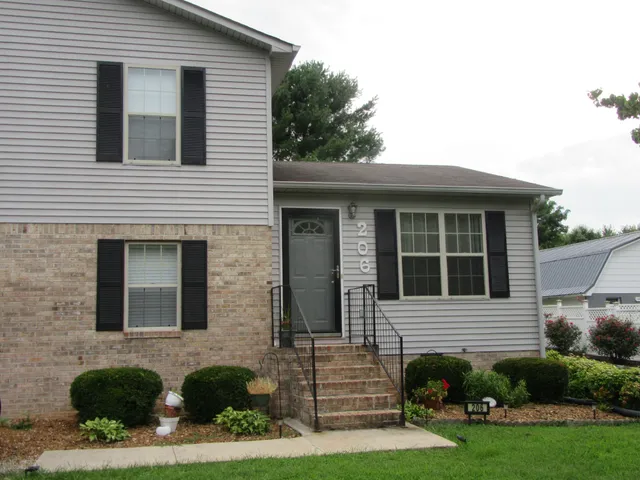 a view of a house with a yard and plants