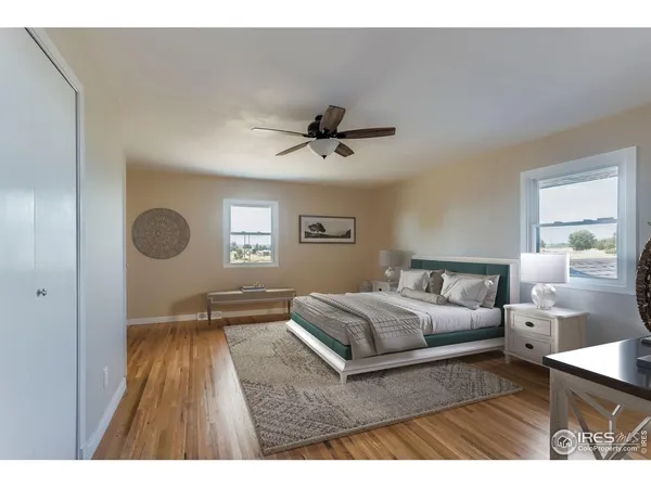 a living room with a bed furniture and a window
