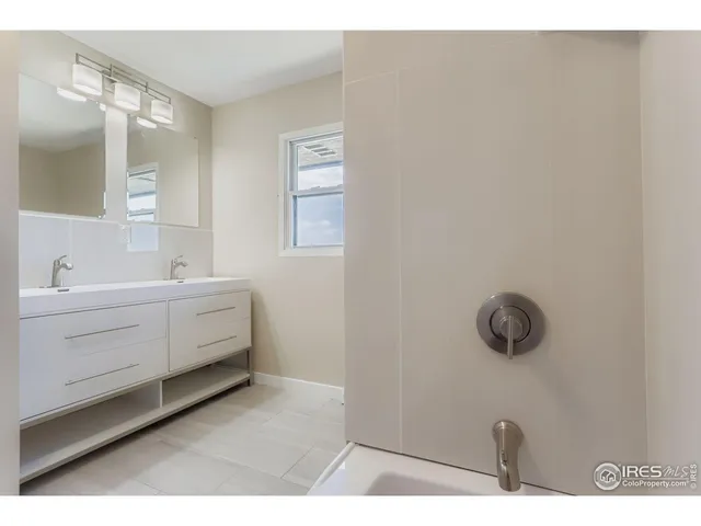 a bathroom with a sink mirror and vanity