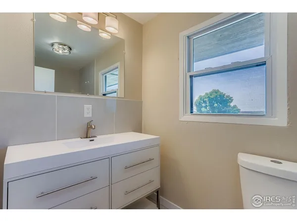 a bathroom with a sink a mirror and a toilet