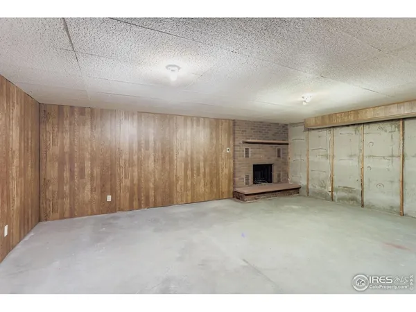 a view of an empty room with a fireplace