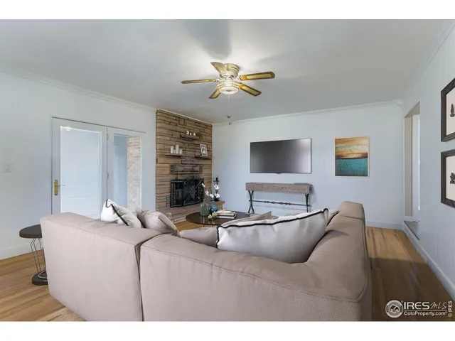 a living room with furniture and a ceiling fan