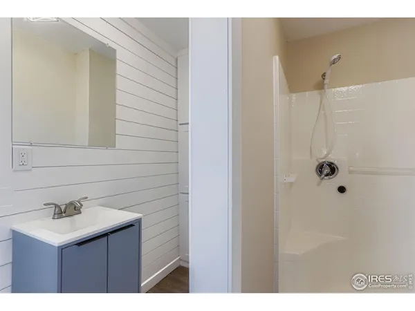a bathroom with a sink a mirror and shower