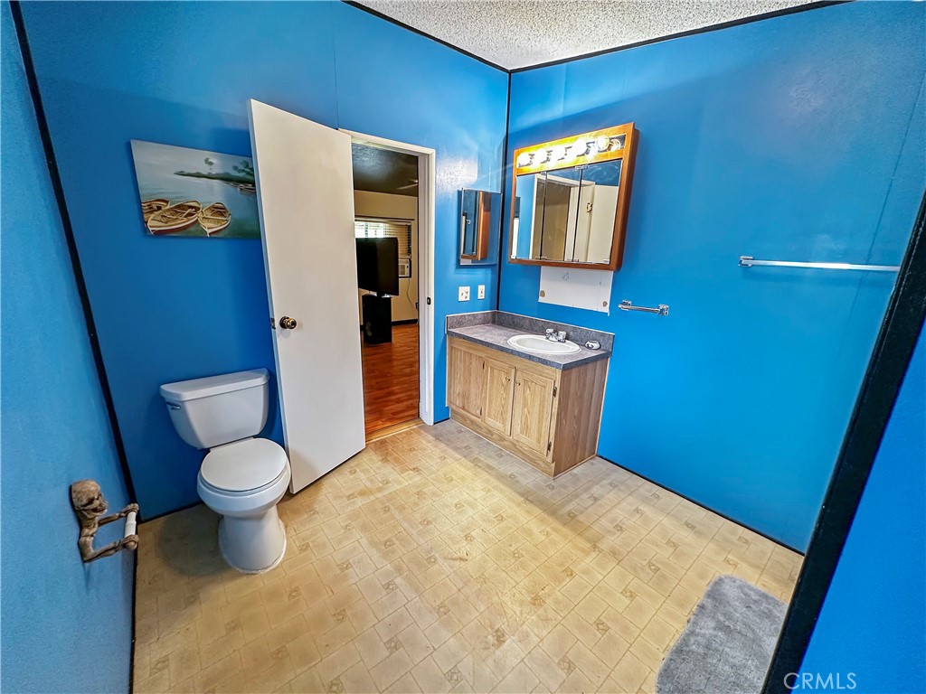 2224 Riviera Drive Blythe, CA 92225 - Photo 12 of 23 a bathroom with a toilet sink and mirror