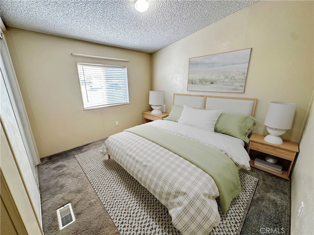 2224 Riviera Drive Blythe, CA 92225 - Photo 8 of 23 a bedroom with a bed and painting on the wall