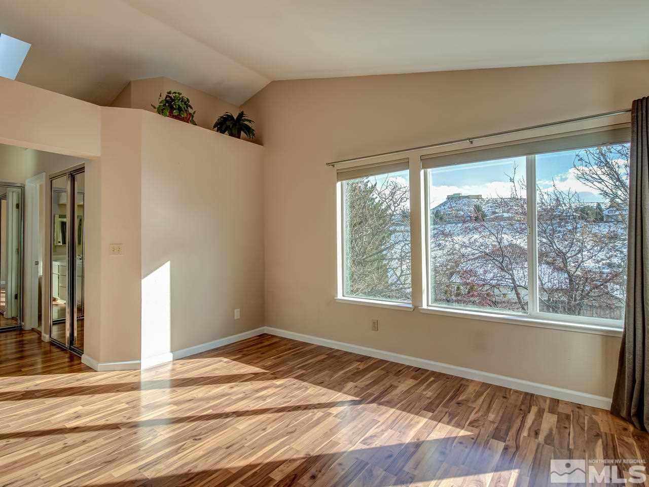 2678 Alpine Creek Road Reno, NV 89519 - Photo 14 of 25 a view of an empty room with wooden floor and a window